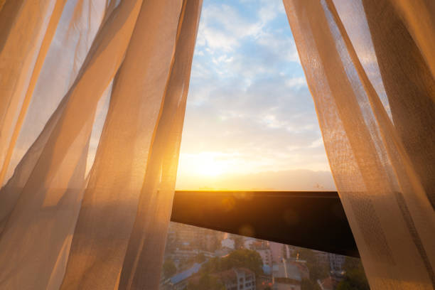Soft sunrise light coming through a bedroom window